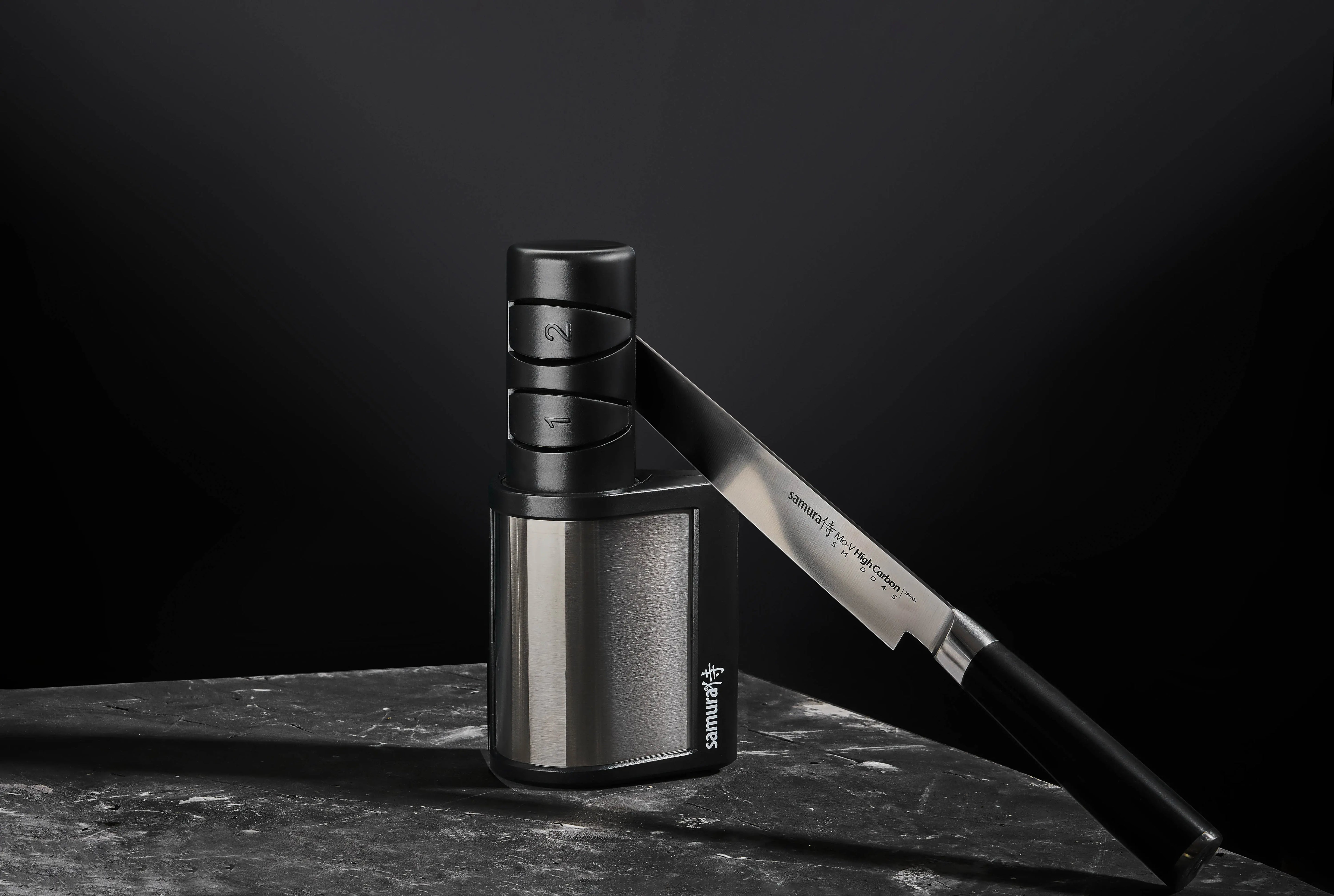 Precision Knives Samura Electric Knife Sharpener with Samura MO-V leaning against it