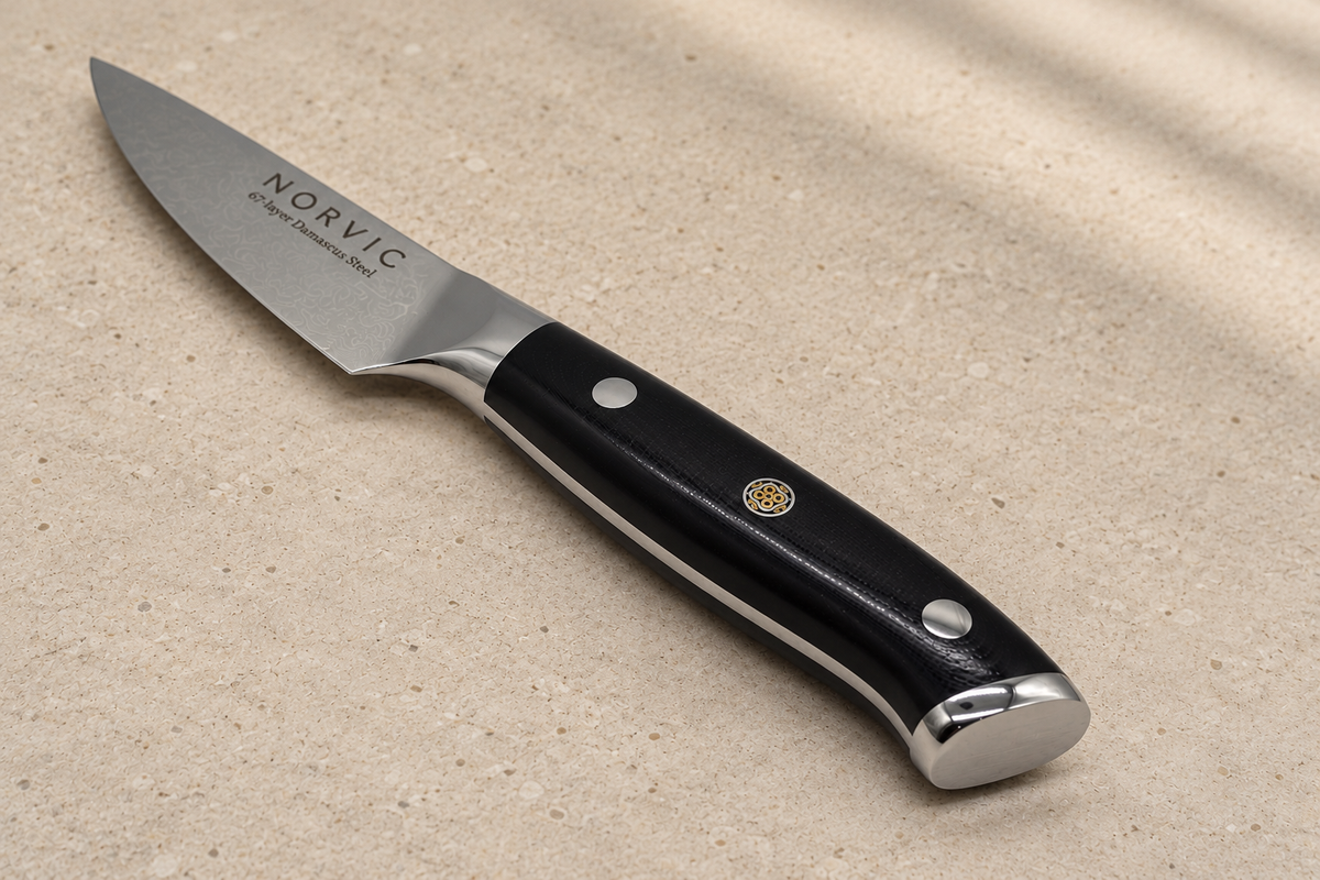 Closer view of the Norvic Worstead 3.5-inch paring knife, showing the black G10 handle, mosaic pin, bolster and Norvic engraving