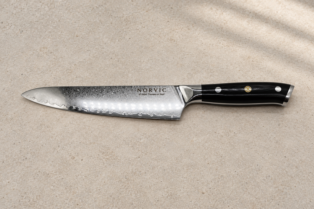 Side profile of the Norvic Worstead 8-inch chef knife, showing the Damascus blade and black G10 handle