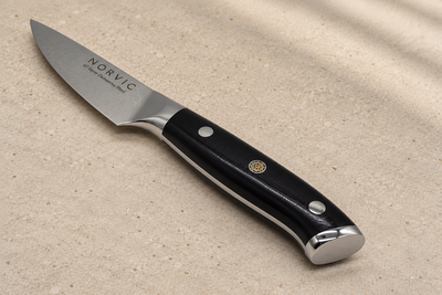 Closer view of the Norvic Worstead 3.5-inch paring knife, showing the black G10 handle, mosaic pin, bolster and Norvic engraving