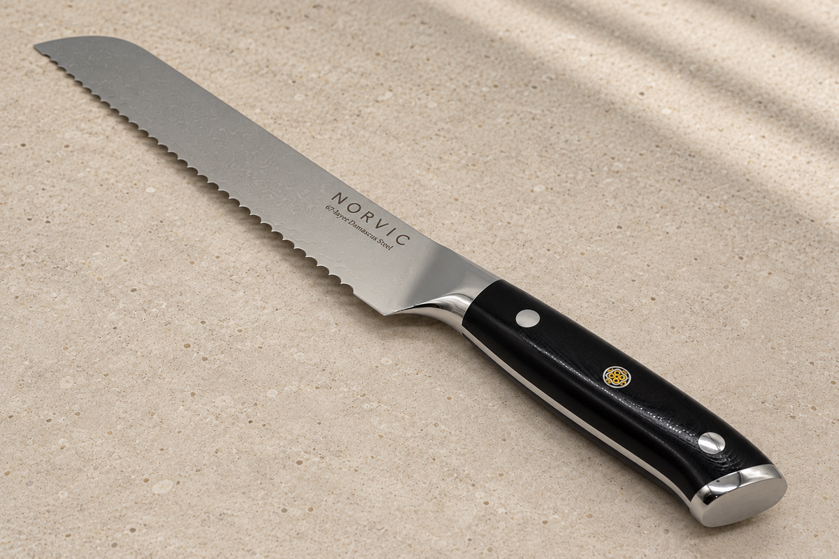Closer view of the Norvic Worstead 8-inch bread knife, showing the black G10 handle, mosaic pin, bolster and Norvic engraving